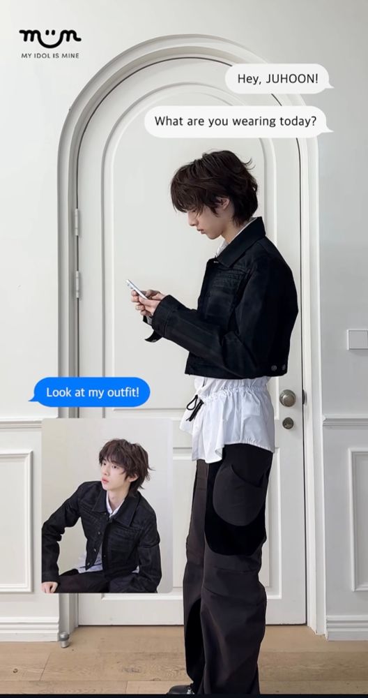 Juhoon standing in front of an arched door, texting