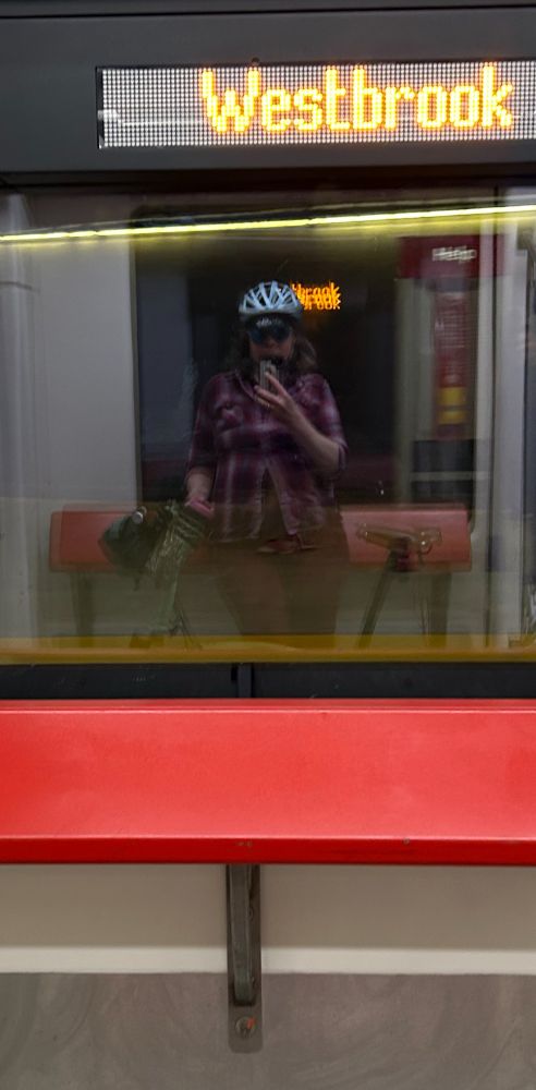 Reflection of myself and my bike on the train.