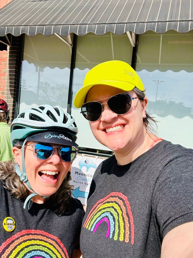 Two people wearing matching rainbow bike chain tshirts from Two Wheel View.