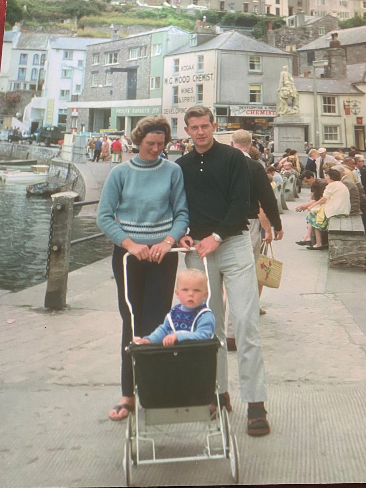Me in a pram, my ma and pa standing behind. The photo is from the late 60s and taken on a pier or harbour wall somewhere in England I guess. In the background is WH Woods Chemist. 