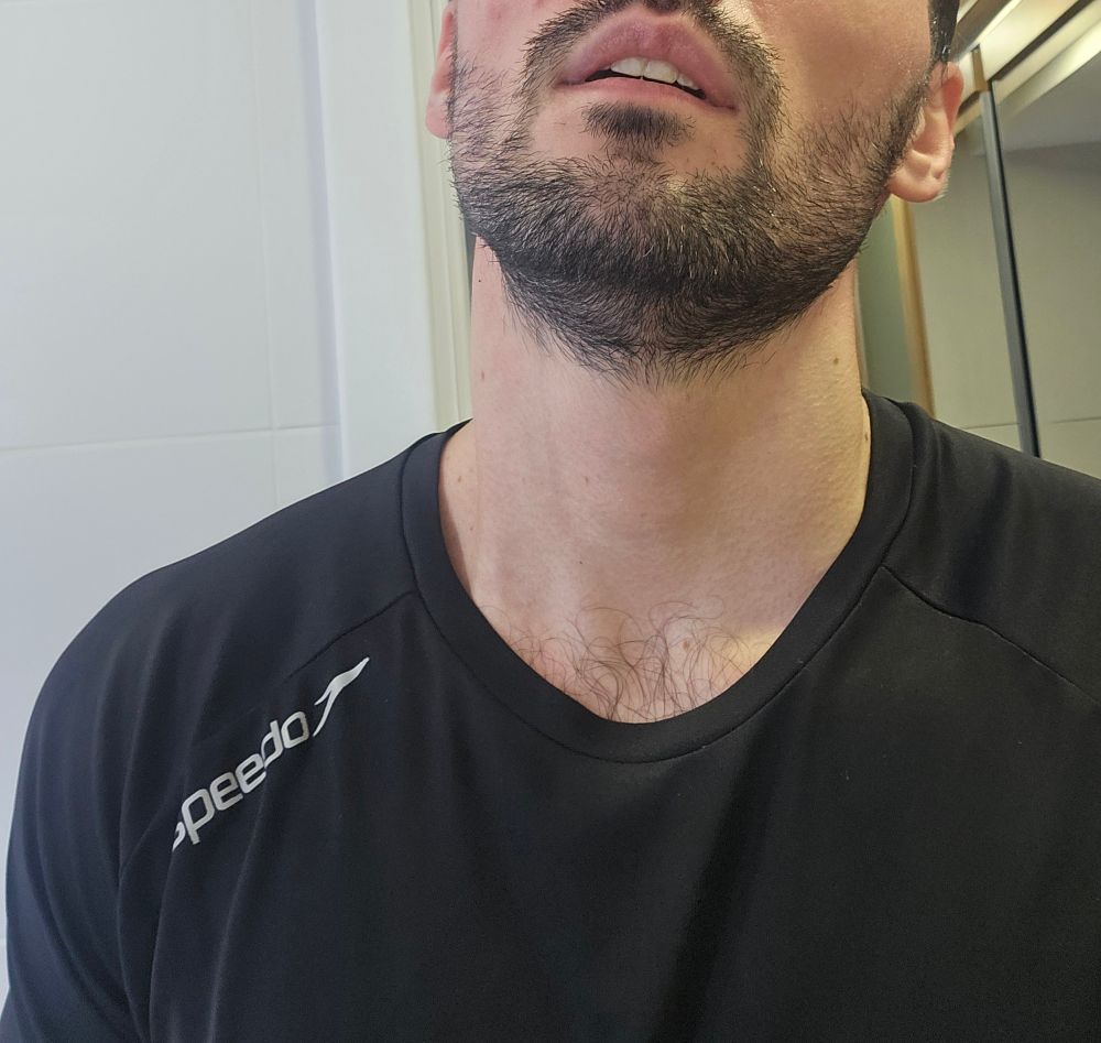 busto de homem suado com camiseta de academia e pelos do peitoral saindo pela gola
