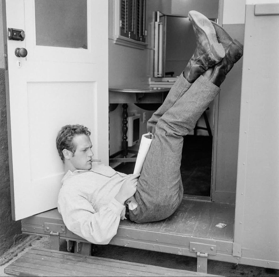 Paul Newman with a paper in an odd position