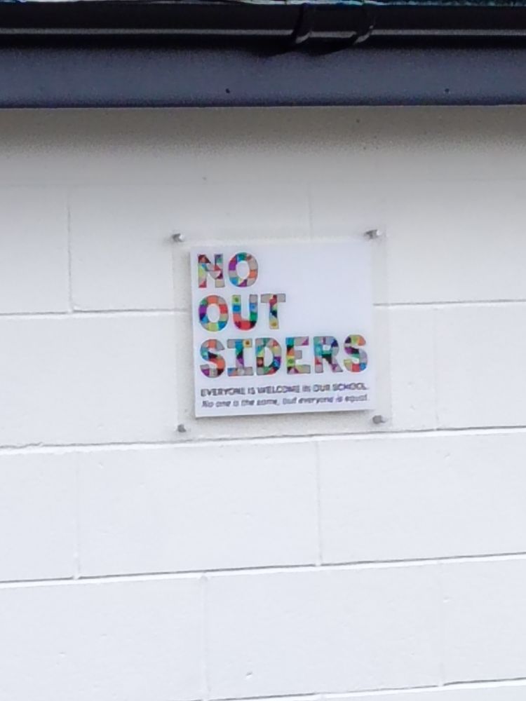 Sign reading "no outsiders"