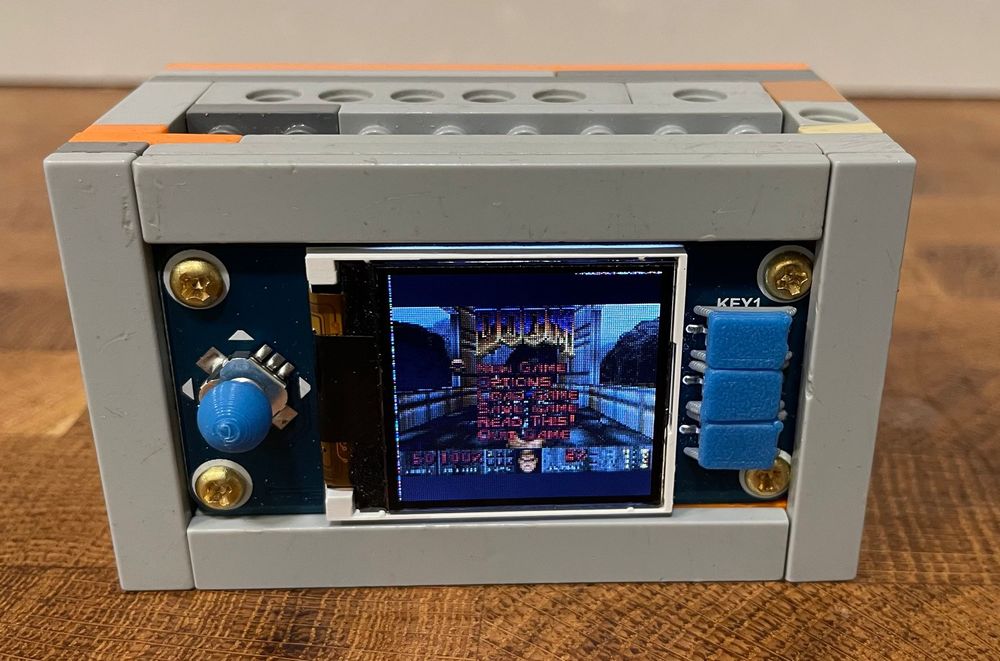 A picture of a handheld console with 3D-printed buttons and joystick ball.