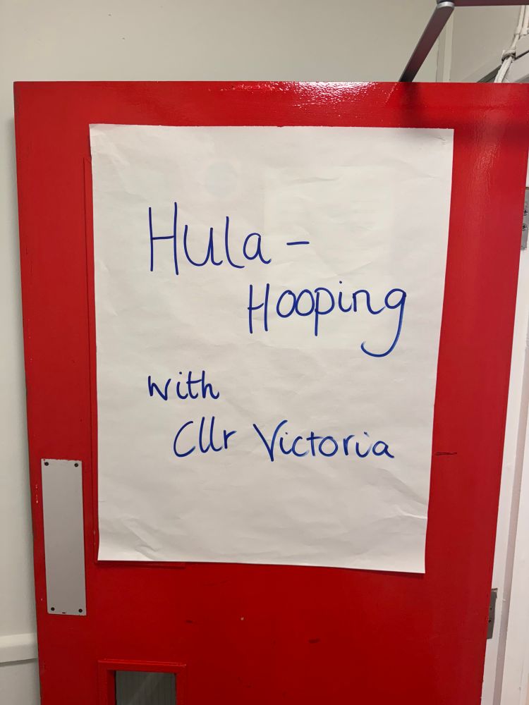 A sign that says “hula hooping with Cllr Victoria”