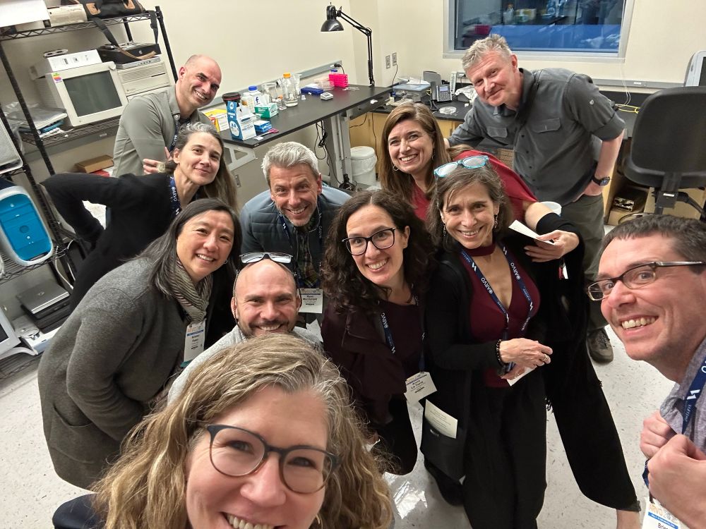 Group selfie of 11 people on a lab tour