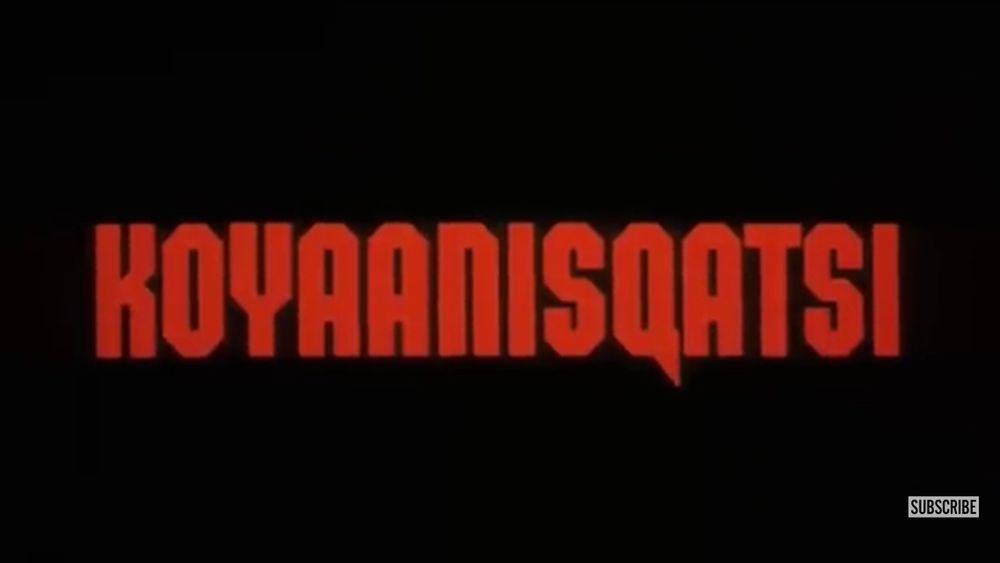 Title screen of Koyaanisqatsi.
Large, red, block-like characters on black. 