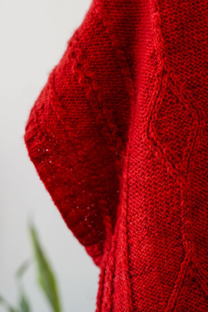 Close-up of the Pathways Vest designed by Sasha Hyre @VeronaKnits made with Norwood yarn in Red Rover