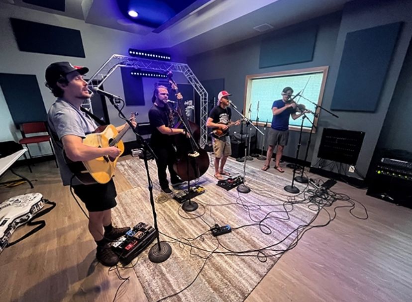 A music group performs in a studio.