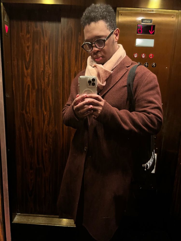 OP blending into brass/wood paneling of haunted elevator. Hair is uncut. 