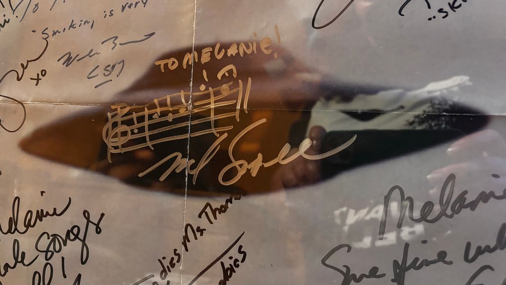 An old I Want to Believe poster with the notes of The X-Files theme written on the UFO by Mark Snow. 