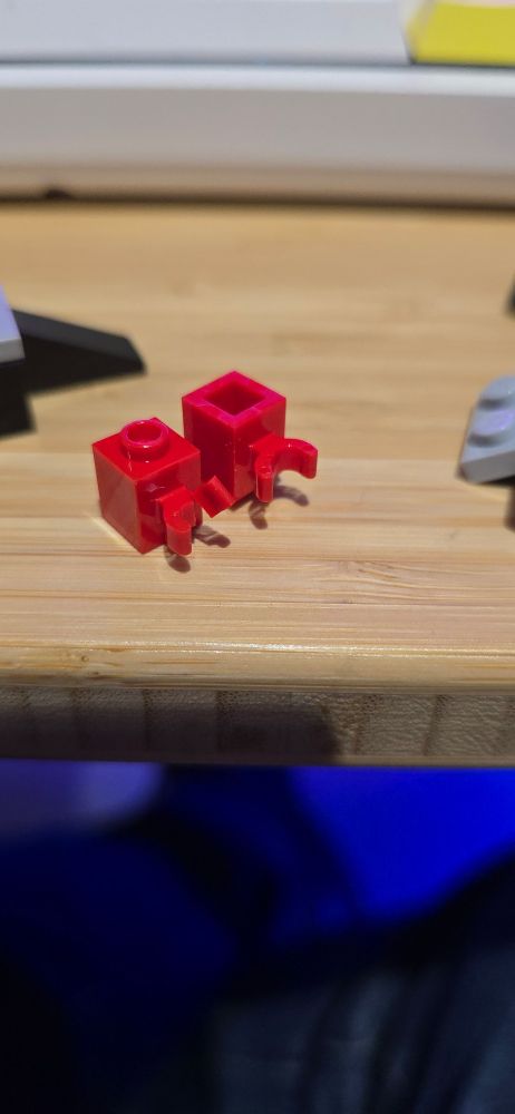 A close up image of two Lego bricks with broken parts