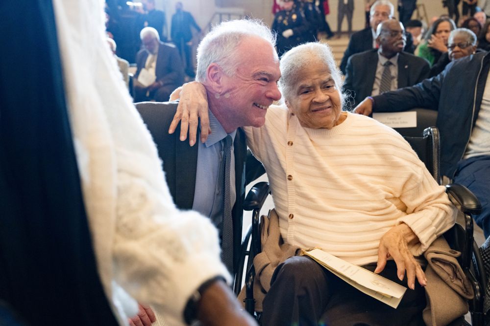 Senator Kaine is embraced by an older woman. 
