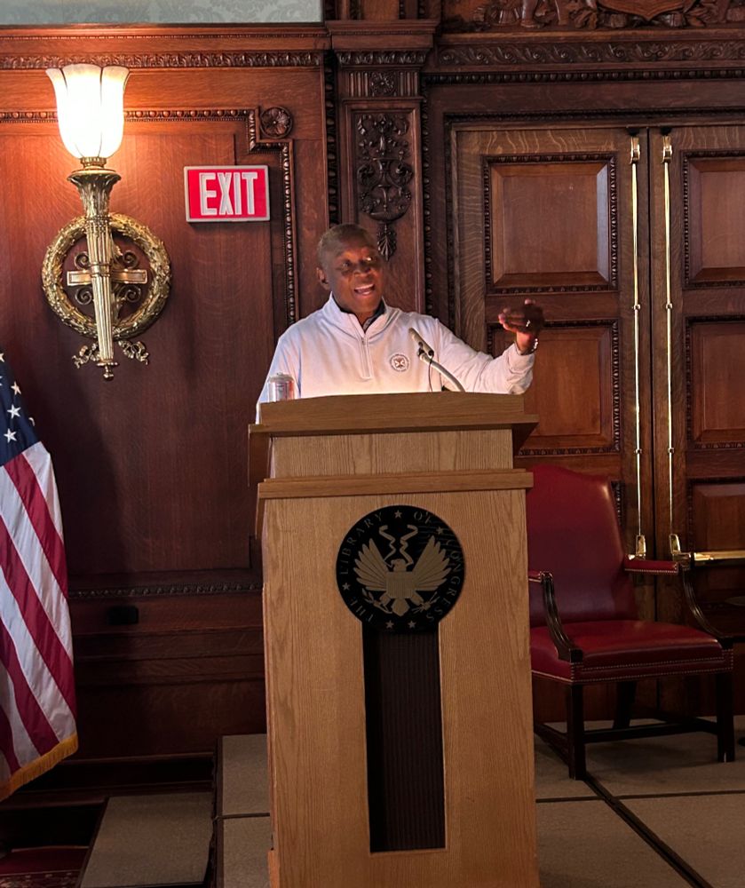Speaker Don Scott delivers remarks at a podium. 