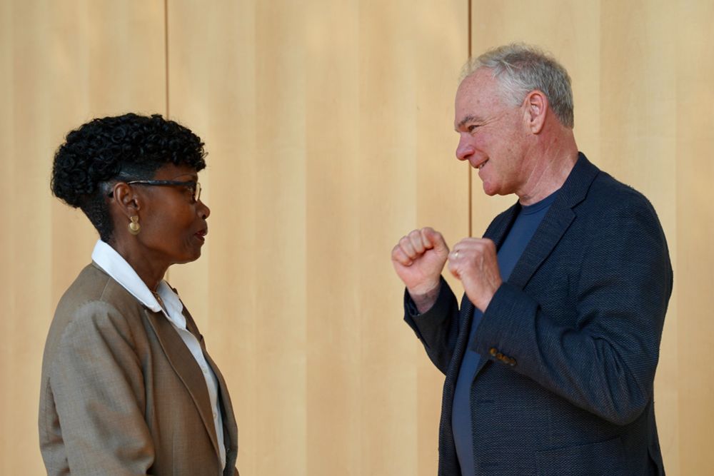 Senator Kaine speaks with a woman. 