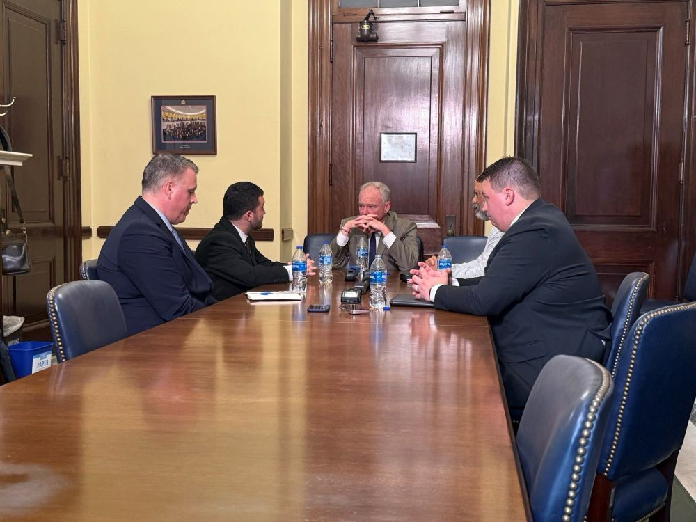 Senator Kaine engages in a conversation at a table with the State Department officers. 