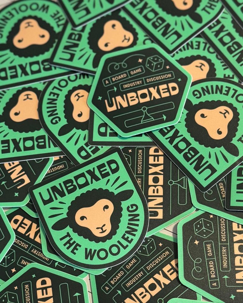 Unboxed board game industry discussion podcast stickers - logo sticker and Woolening sticker (a reference to a fake product in several episodes)