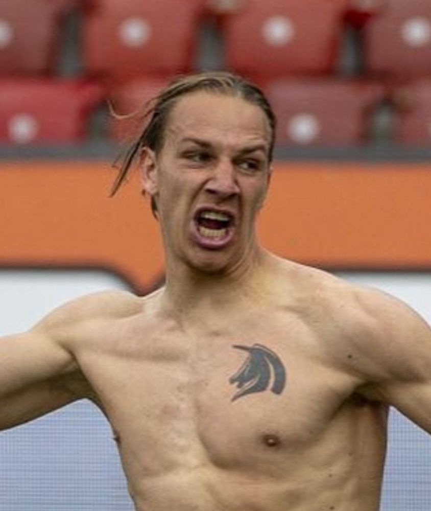 2018 Michi Frey (with hair!!!) celebrating a goal. He’s removed his top to reveal a unicorn tattoo