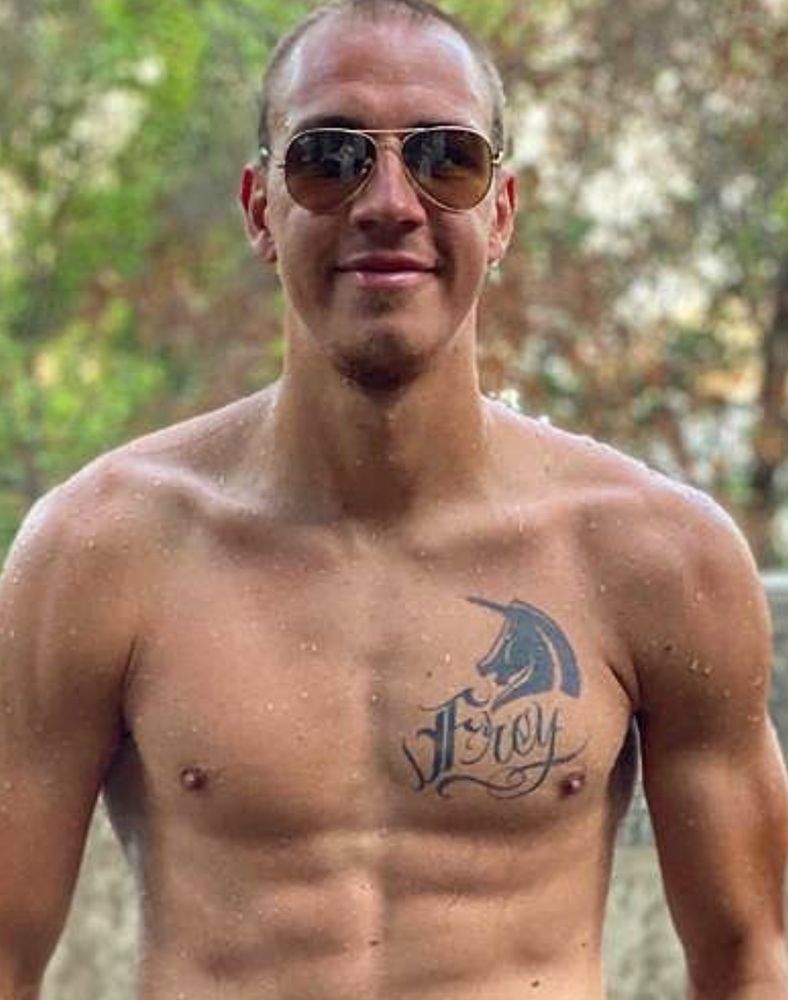 2020 Michi Frey chilling by the pool. As his hair decreases, his tattoos increase. It now reads ‘Frey’ beneath the unicorn tattoo
