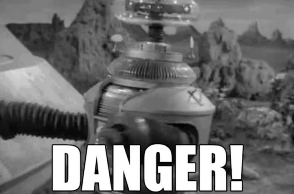 a black and white photo of a robot with the words danger written below it