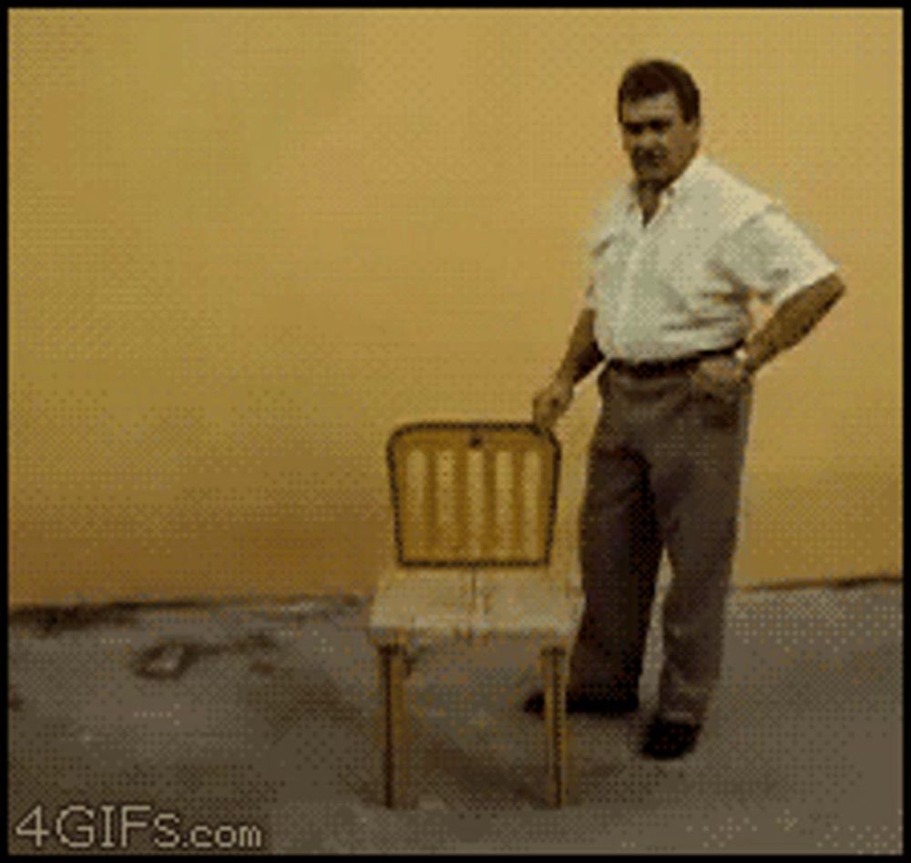 a man is standing next to a chair with a 4gifs.com watermark in the corner