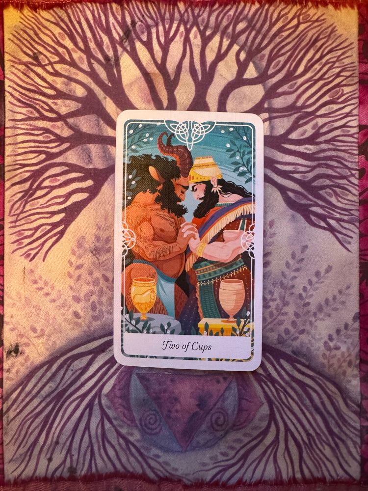 Tarot card of the Two of Cups from Yoshi Yoshitani's Tarot of the Divine deck. The card depicts Enkidu and Gilgamesh from Sumerian myth. 