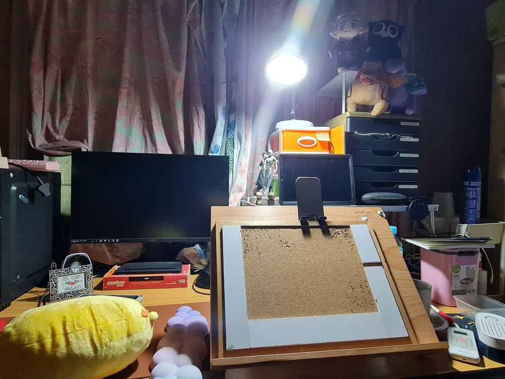 Art workspace table with a PC tower, monitor, table easel, and drawers. 