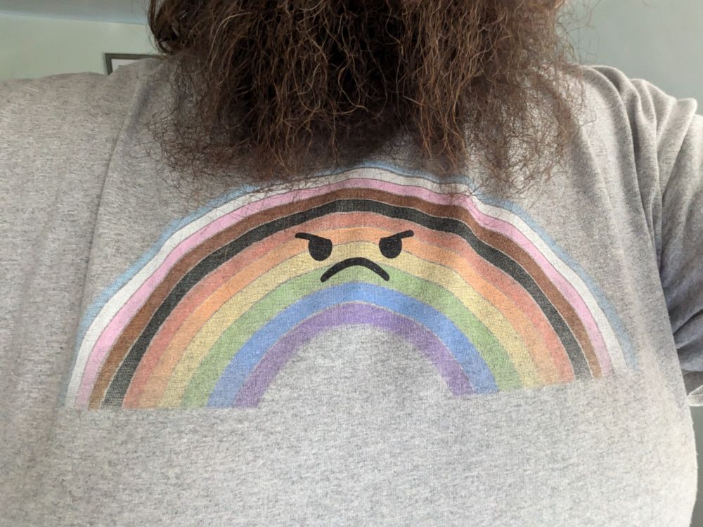 Trans+poc inclusive pride rainbow with a frowny face