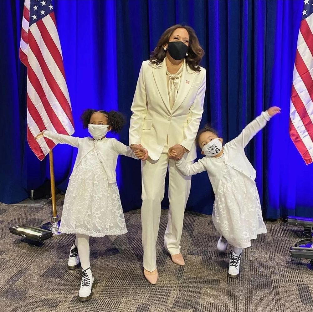 Kamala Harris after becoming VP-elect in 2020, holding hands with her nieces, her eyes beautifully expressing her joy. The little girls are in matching white lace dresses and tights, wearing white shoes with black laces and white masks, while their Auntie Kamala is in a white suit and a black mask.

The three of them in white is a tribute to the suffragists who fought for women to be able to vote, as this woman who should have been our 47th president would have fought for all our rights. She would have brought this country closer to the ideals it has always paid lip service to but seldom embodied. 