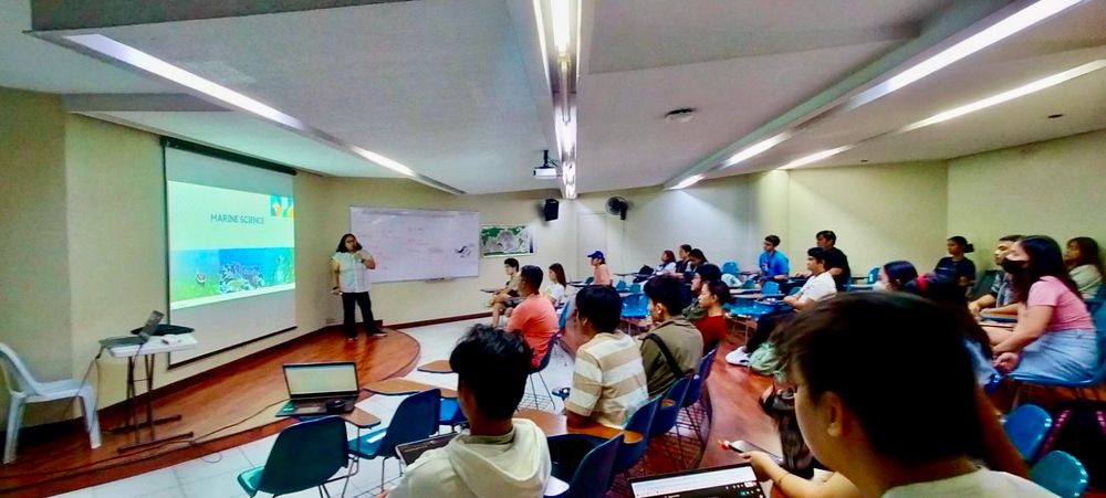 Woman giving a talk on marine science communication in front of a class