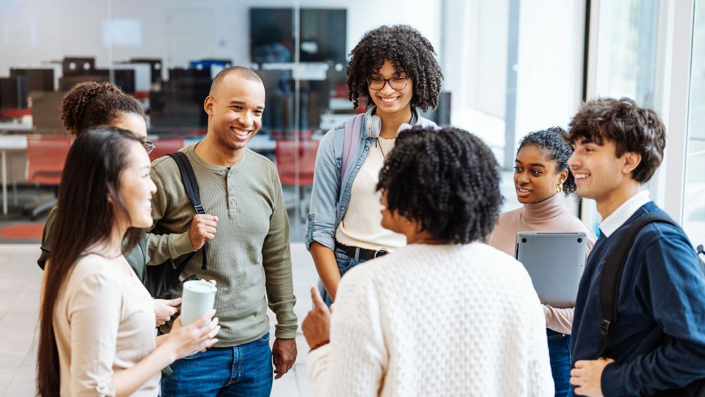 A group of students engaging in conversation. 