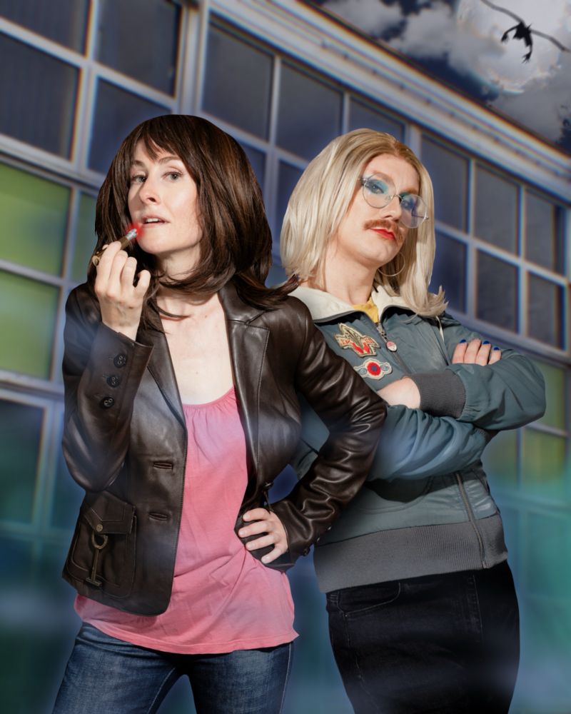 Sadie Miller as Sarah Jane poses with Carrot as Rose, back to back. Sarah Jane holds her sonic lipstick up to her mouth. Rose looks sassy. Behind them is an edited in background of a school building, with a full moon in the sky above, against which is silhouetted a flying Krillitane.