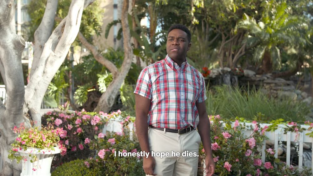 a picture of actor Sam Richardson walking through a park garden in a sketch from I Think You Should Leave with the subtitle text of his character saying “i honestly hope he dies” because this site doesn’t have gifs for some reason.