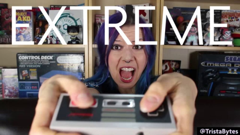 a woman with purple hair is holding a nintendo controller and the words extreme are behind her