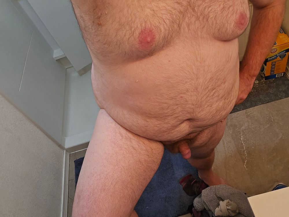 Lewd's naked body. Their cock is softening as they had just masturbated. They are standing triumphantly.