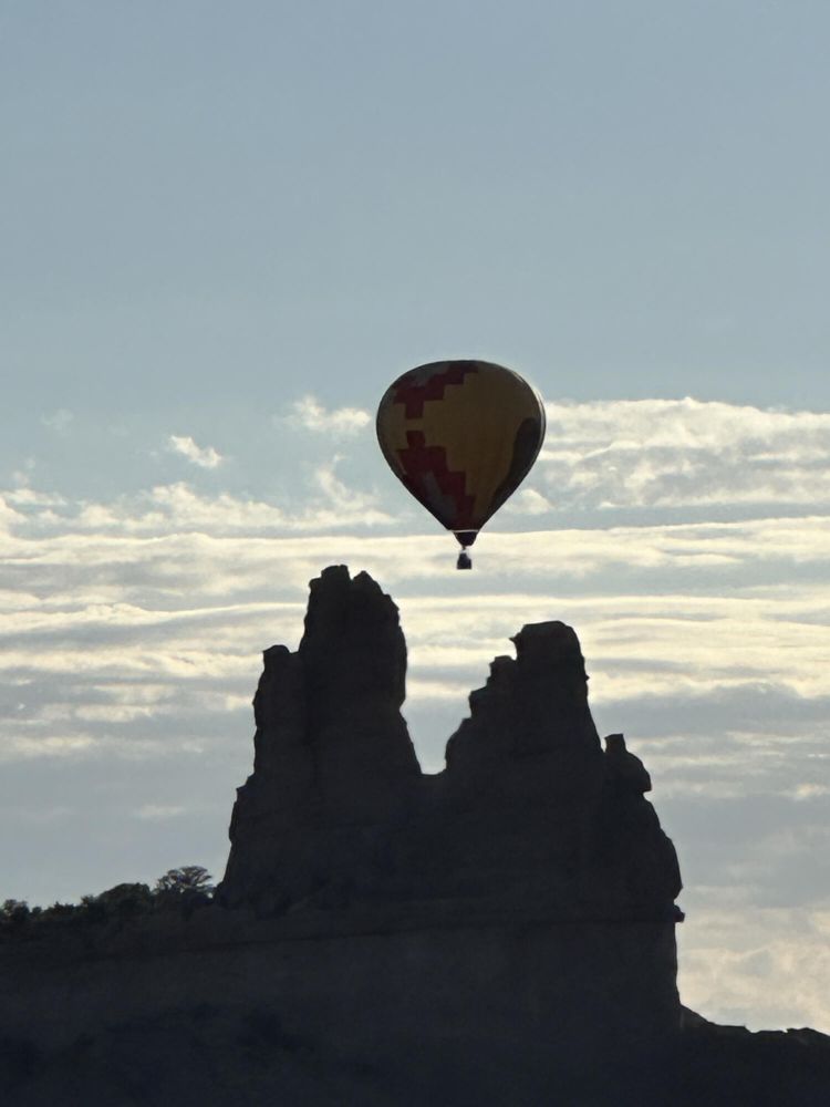 Balloon silhouetted in front of Church Rock