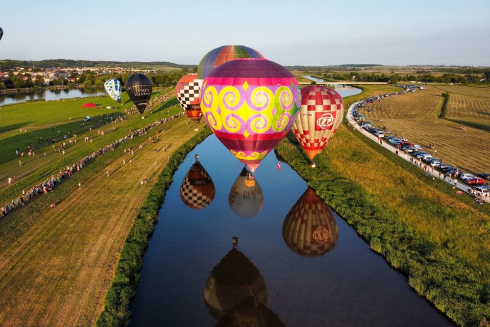 Tiedyed hot air balloon over a canal