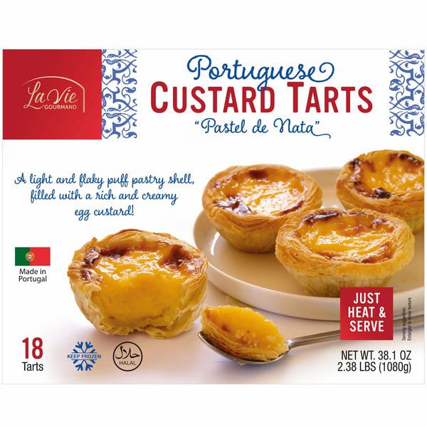 the box from "la vie" branded Portuguese egg tarts, or "pastel de nata". there are three on the cover, like little egg custard pies with browned tops. it's a box of 18. 