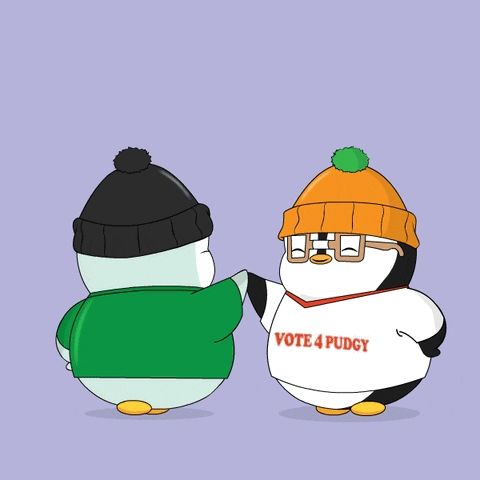 two penguins are standing next to each other one wearing a vote 4 pudgy shirt