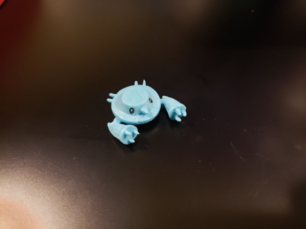 A Metang figure. It's a light blue and has beady little eyes.