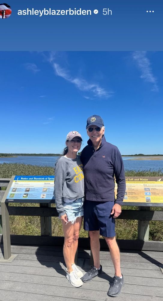 Biden and his daughter posing on the boardwalk at the beach