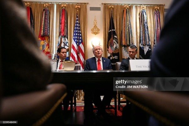 Getty photograph with Trump looking like he has horns (light fixture behind him)