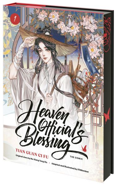 gorgeous artwork of Xie Lian on the cover of a hardcover copy of Heaven Official's Blessing with black spray edges and red butterflies and flowers. 