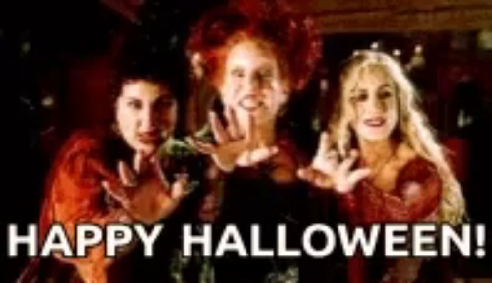 three women in witch costumes are standing next to each other with the words happy halloween written below them .