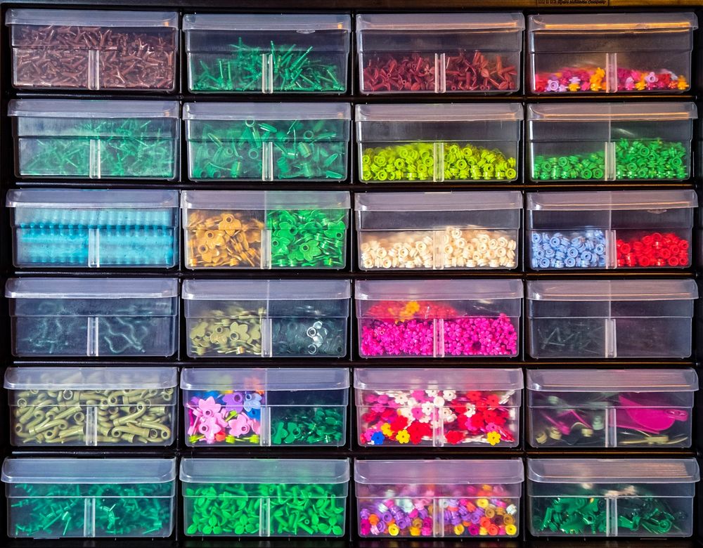 Lego plant pieces are organized by type in a hardware cabinet with small drawers.