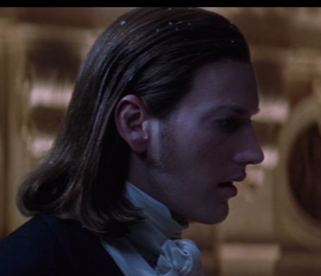 raoul from the 2004 phantom of the opera film at a profile view. his sideburn appears to connect to his real hair under the wig by way of directly underneath his ear, something i have never seen on a human being before.