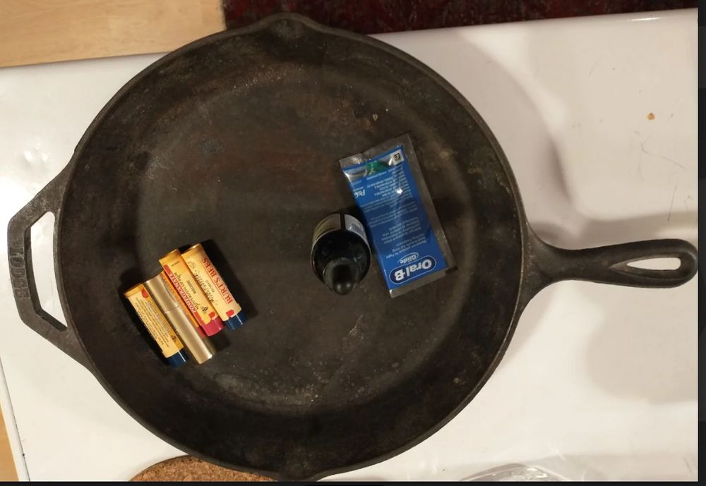 Lip balms and sundries in a cast iron frying pan