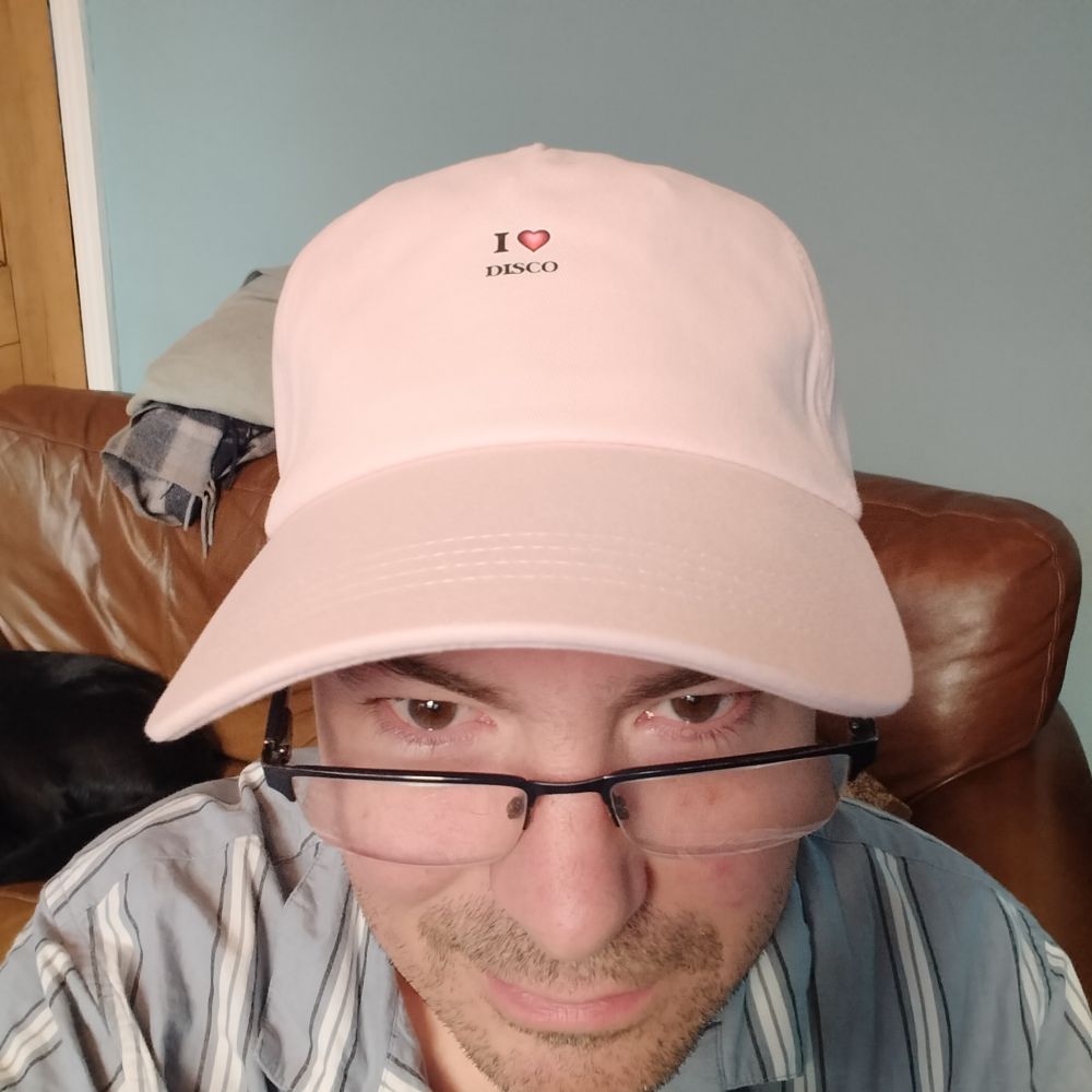 Me in a new pink baseball cap, bearing the statement 'I ♥️ DISCO' 