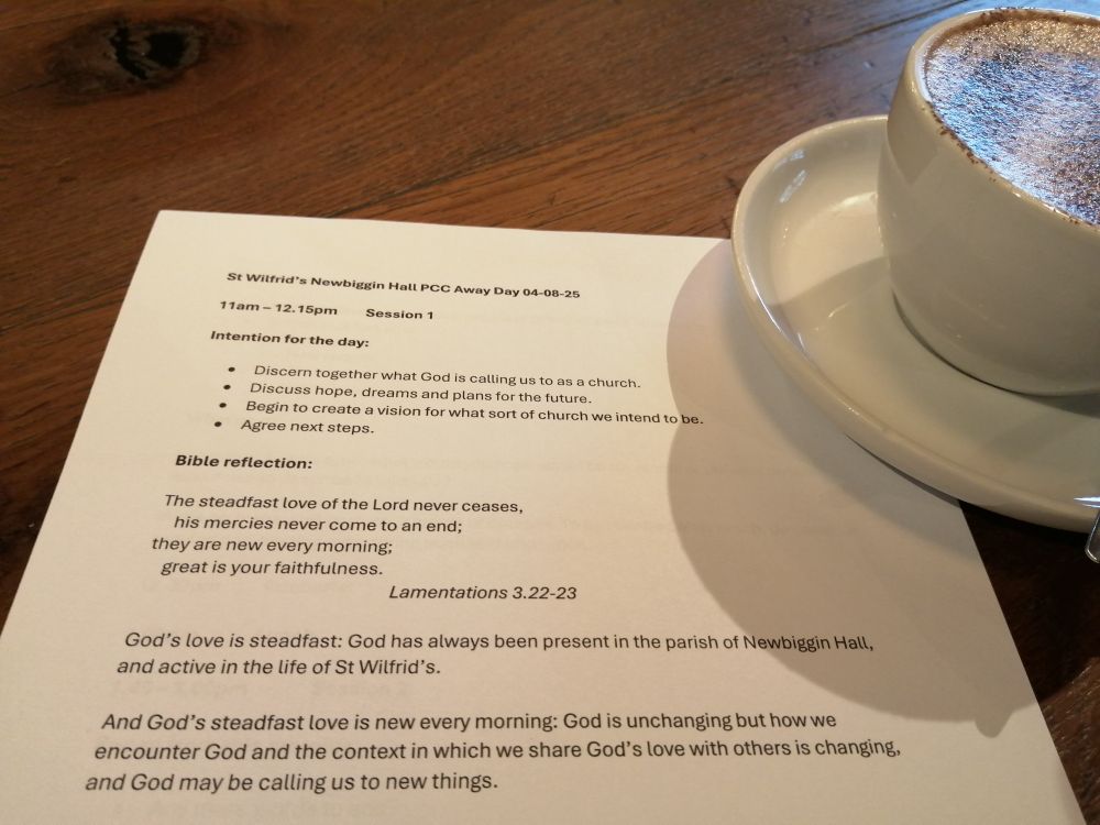 Planning notes on a table with a cup of hot chocolate. 