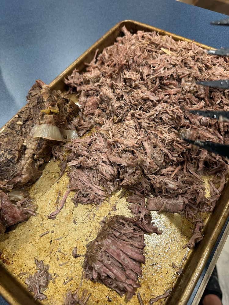 Shredded chuck roast on a pan ready for some tortillas